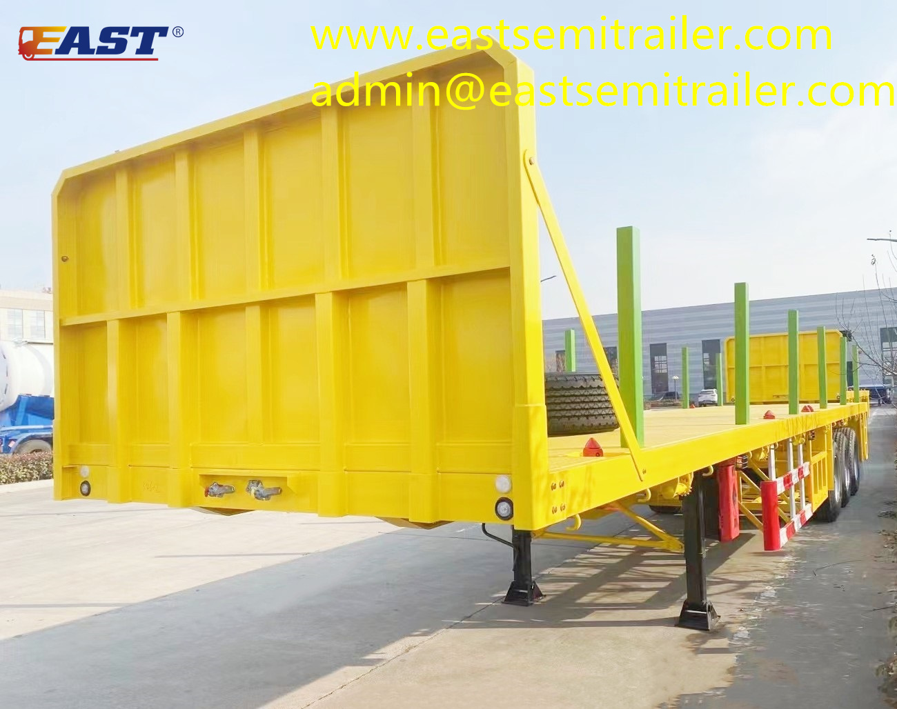 Three-axle flatbed trailer with stakes and front fender